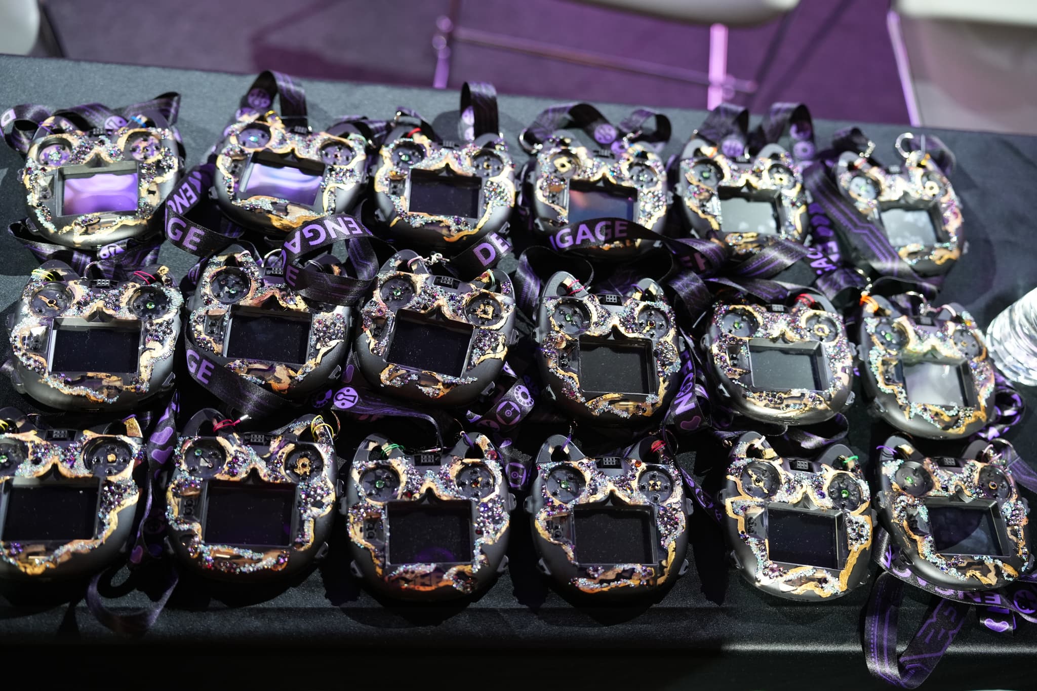 Multiple medals with intricate designs and purple ribbons arranged on a table